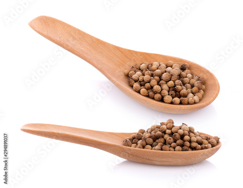 coriander seeds in spoon wooden on white background