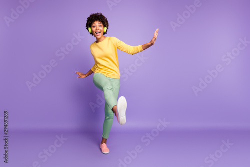 Full length body size view of nice attractive cheerful cheery crazy clumsy wavy-haired girl listening music having fun strolling fooling dancing isolated on violet purple lilac pastel color background