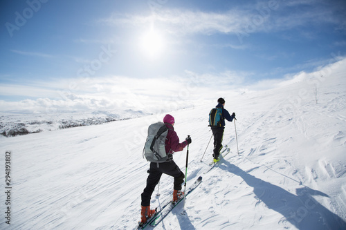 Two people cross country skiing