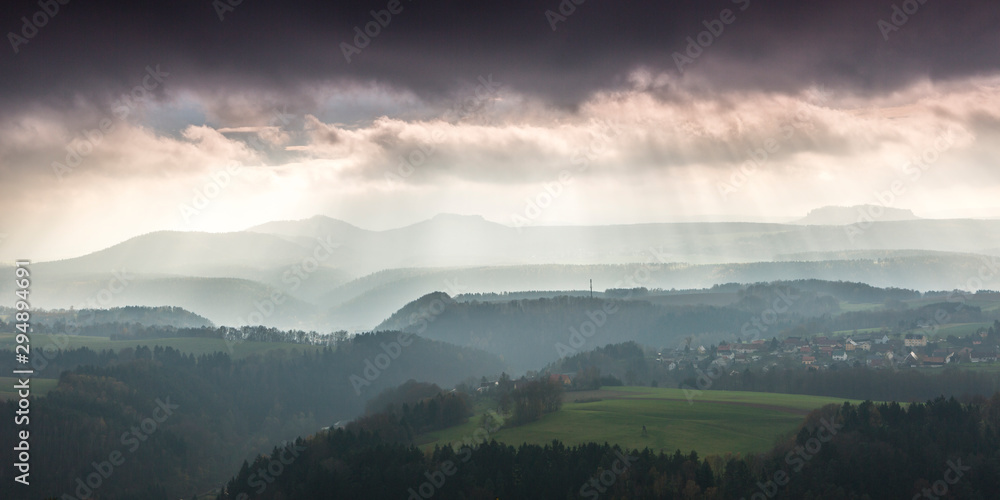 View across Elbstandstein mountains Autuum mood with dark clouds. Traveling in East Germany.