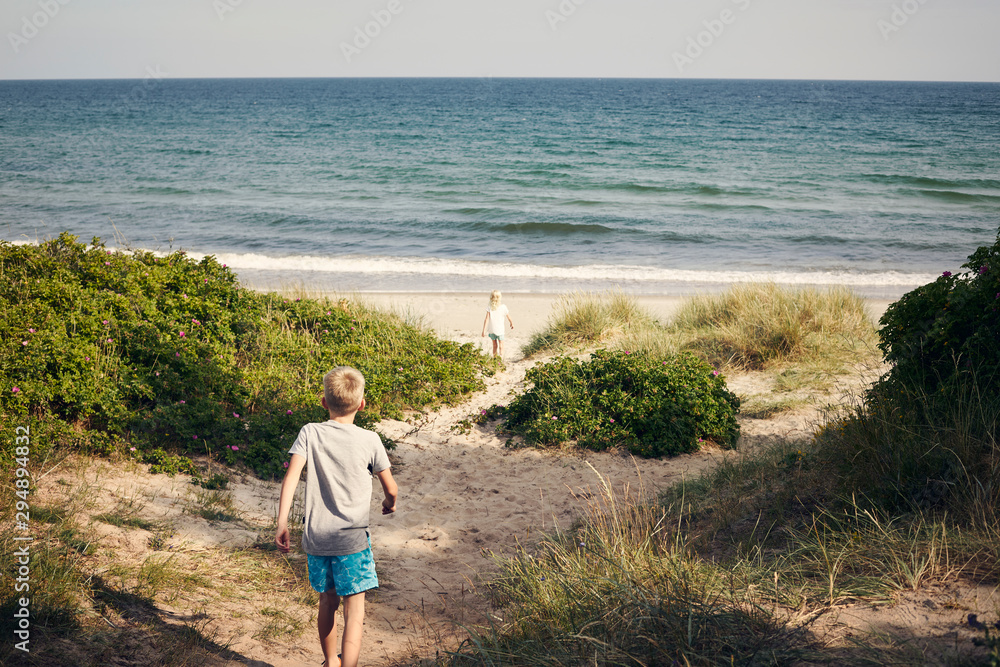 Boy and girl walking to beach Boy and girl walking to beach