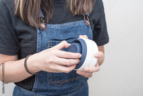 Fotografija Young woman holding a silicone collapsible cup, reusable coffee tumbler