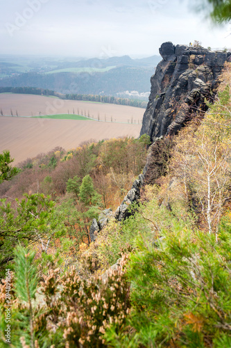 View on top of Lilienstein Plateau. Autuum mood with dark clouds, Elbstandstein mountains landscape. Traveling in East Germany. photo