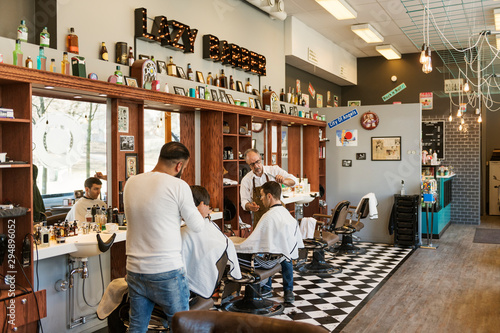 Barbers cutting customer?s hair photo