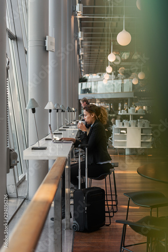 Woman using laptop in airport photo