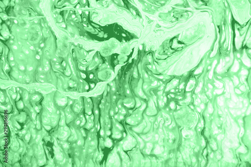 Abstract background made with fluid art technique in light green mint color. Trendy colorful backdrop