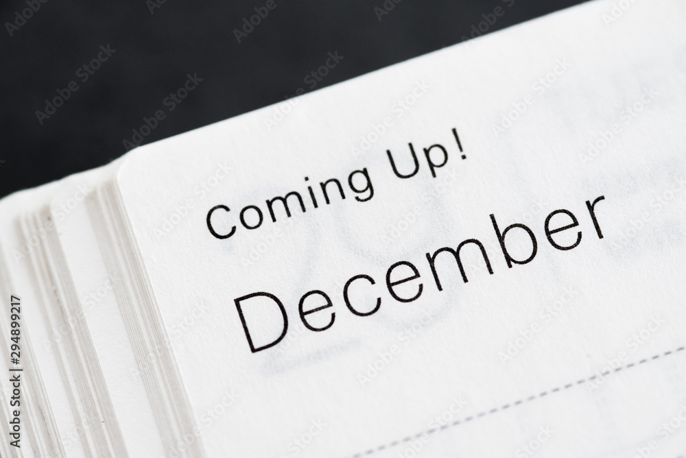 Coming Up! December, months of a year. Macro shot of a monthly planner.