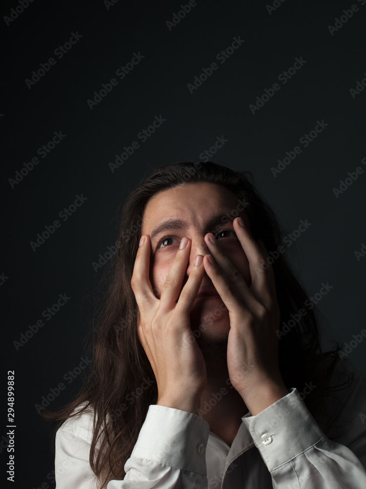 Portrait of unhappy young man. Hands on face Portrait of unhappy young man. Hands on face