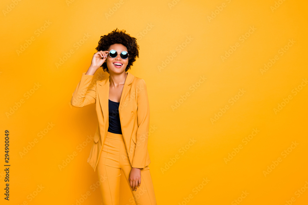 Portrait of her she nice fashionable attractive luxurious cheerful cheery wavy-haired girl touching specs isolated over bright vivid shine vibrant yellow color background