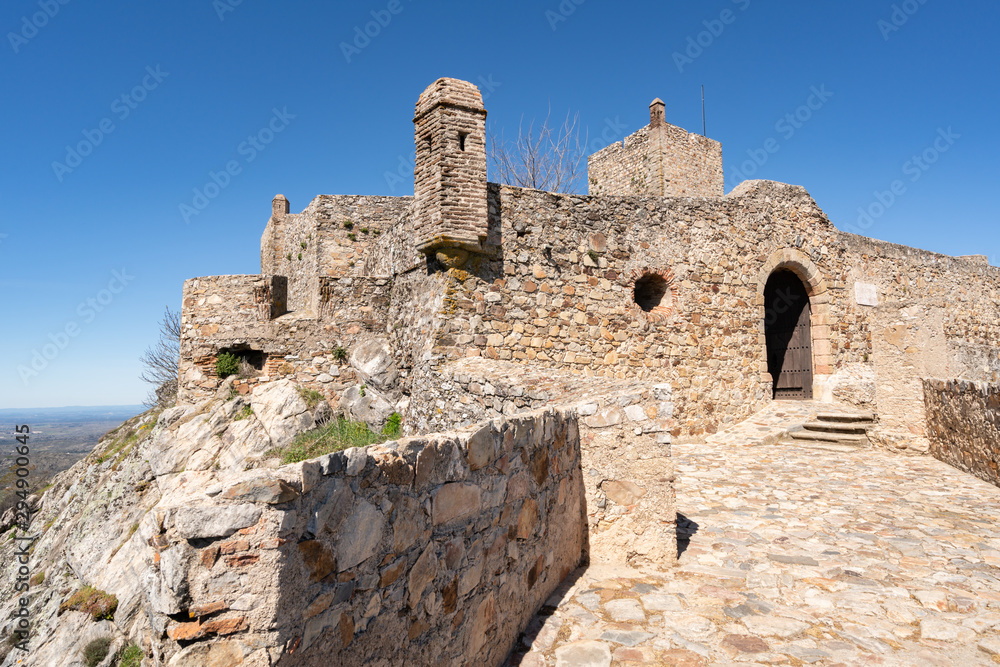 Marvao castle on the top of a mountain with beautiful green landscape behind on summer, in Portugal