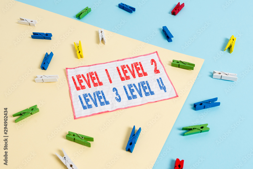 Conceptual hand writing showing Level 1, 2, 3 and 4. Concept meaning Steps levels of a process work flow Colored clothespin paper reminder with yellow blue background Conceptual hand writing showing Level 1, 2, 3 and 4. Concept meaning Steps levels of a process work flow Colored clothespin paper reminder with yellow blue background