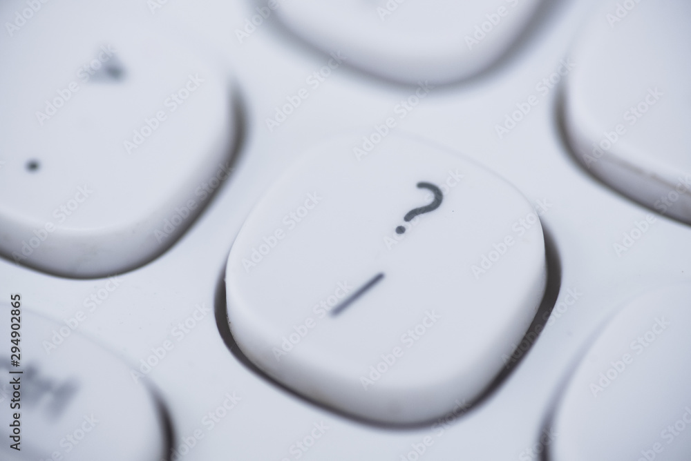 Close-up of Question mark key of a white keyboard. Close-up of Question mark key of a white keyboard.