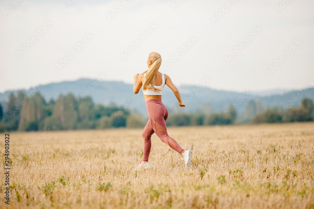Athletic young blonde girl is jogging in park dawn, concept running for health Athletic young blonde girl is jogging in park dawn, concept running for health