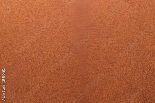 Orange-brown grainy, heavy grain calf cow leather texture and background.