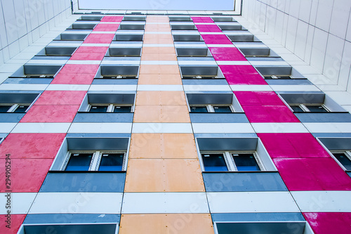 multi-storey residential building with colorful inserts