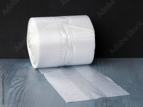 Clear gusseted poly bags on roll over wooden table