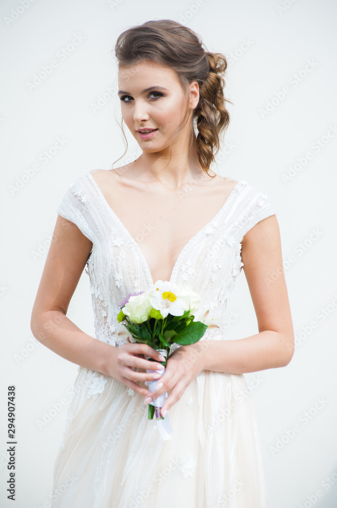 Beautiful bride with wedding flowers bouquet, attractive woman in wedding dress. Happy newlywed woman. Bride with wedding makeup and hairstyle. Smiling bride. Wedding day. Gorgeous bride. Marriage. Beautiful bride with wedding flowers bouquet, attractive woman in wedding dress. Happy newlywed woman. Bride with wedding makeup and hairstyle. Smiling bride. Wedding day. Gorgeous bride. Marriage.
