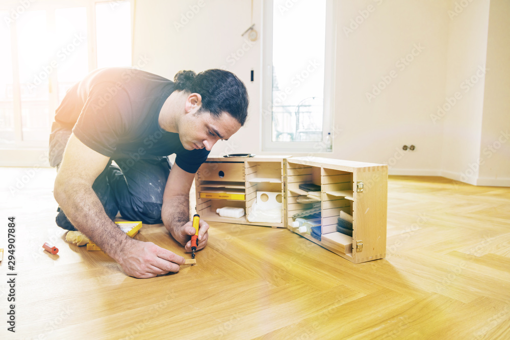 Craftsman corrects imperfections in the parquet with a repair set Craftsman corrects imperfections in the parquet with a repair set