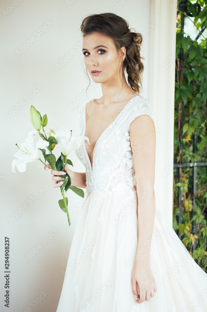 Beautiful bride with wedding flowers bouquet, attractive woman in wedding dress. Happy newlywed woman. Bride with wedding makeup and hairstyle. Smiling bride. Wedding day. Gorgeous bride. Marriage. Beautiful bride with wedding flowers bouquet, attractive woman in wedding dress. Happy newlywed woman. Bride with wedding makeup and hairstyle. Smiling bride. Wedding day. Gorgeous bride. Marriage.