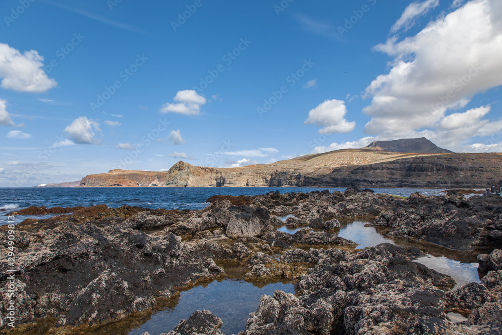 paisaje de roca volcánica con mar en salinas de Agaete