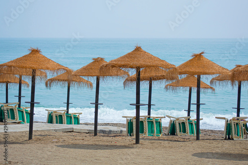 Fototapeta Naklejka Na Ścianę i Meble -  Hamacas y sombrillas en la playa / Sun beds and umbrellas on the beach. Rincón de la Victoria. Málaga