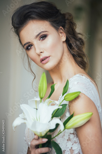 Portrait of bride in wedding dress with wedding bouquet