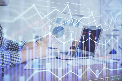 Multi exposure of financial graph with man works in office on background. Concept of analysis.