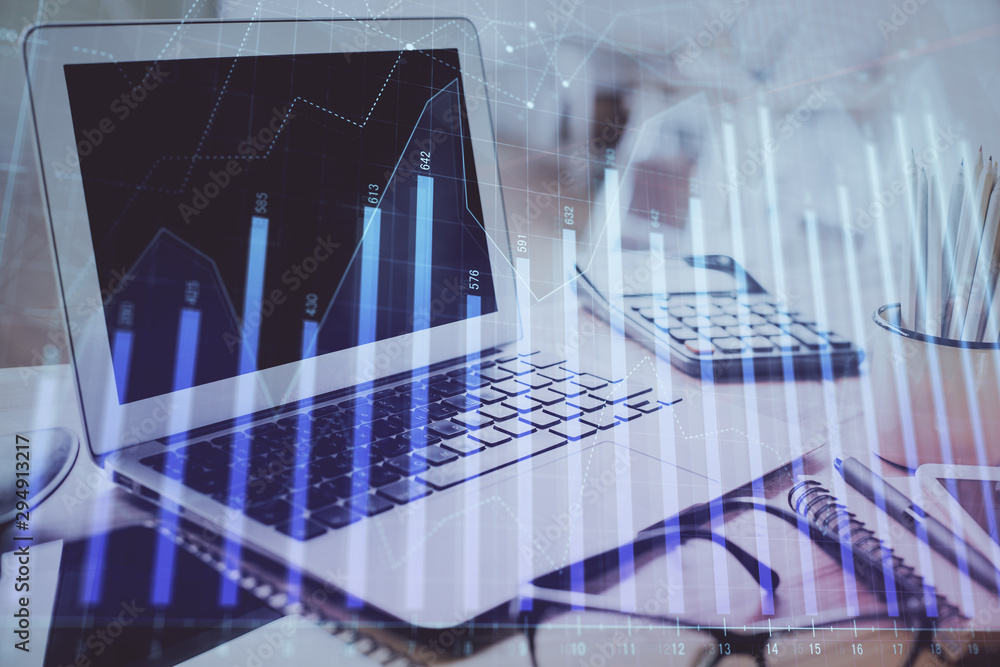Forex graph hologram on table with computer background. Multi exposure. Concept of financial markets. Forex graph hologram on table with computer background. Multi exposure. Concept of financial markets.