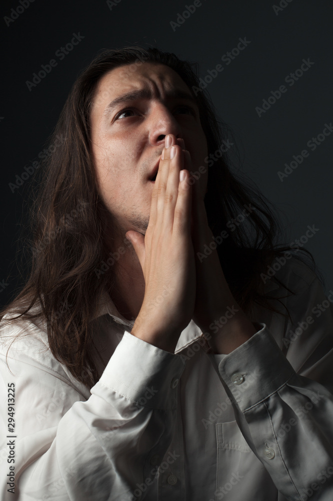 Portrait of unhappy man with long hair. Studio Portrait of unhappy man with long hair. Studio