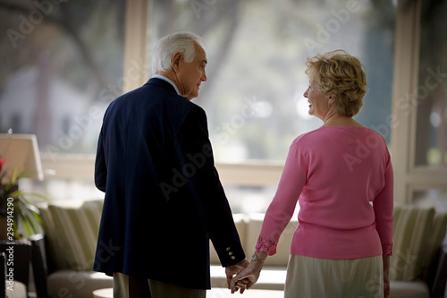 elderly couple holding hands
