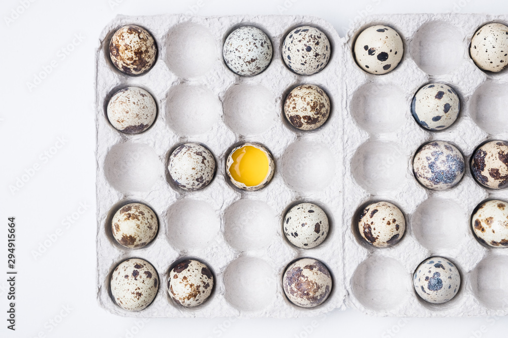 cardboard box with quail eggs on a white table cardboard box with quail eggs on a white table
