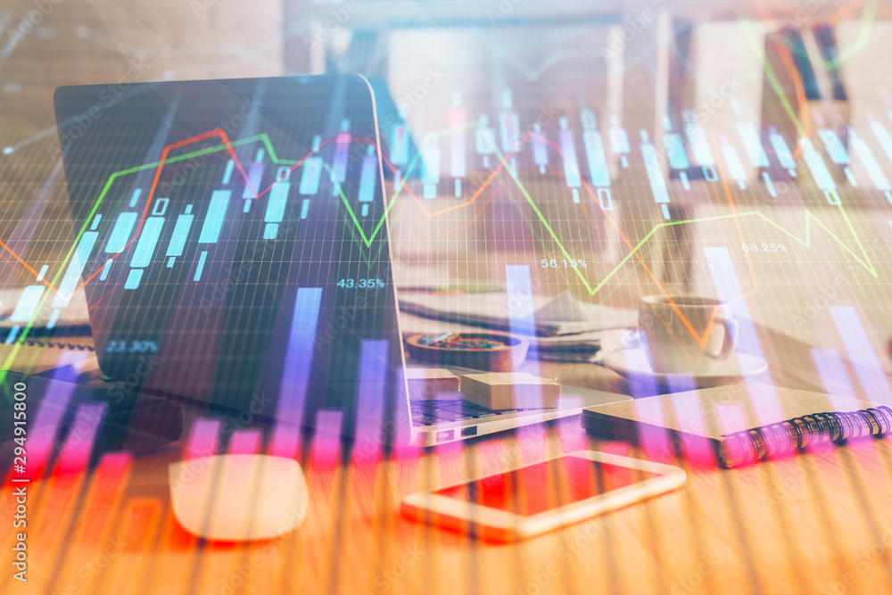 Financial chart drawing and table with computer on background. Double exposure. Concept of international markets. Financial chart drawing and table with computer on background. Double exposure. Concept of international markets.