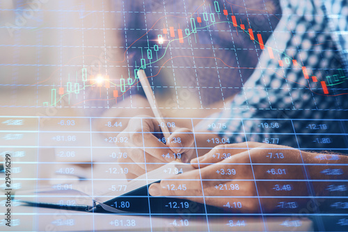 Multi exposure of two men planing investment with stock market forex chart.