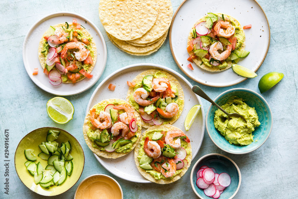 Shrimp tostada with freshly made guacamole, diced tomato and crunchy radish Shrimp tostada with freshly made guacamole, diced tomato and crunchy radish