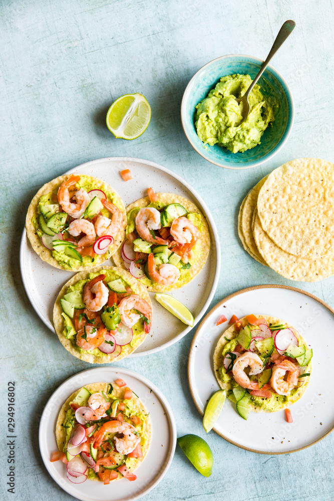 Shrimp tostada with freshly made guacamole, diced tomato and crunchy radish Shrimp tostada with freshly made guacamole, diced tomato and crunchy radish