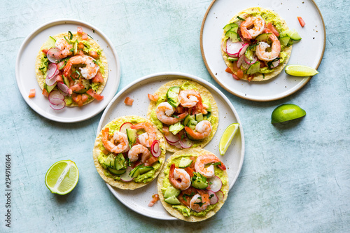 Shrimp tostada with freshly made guacamole, diced tomato and crunchy radish