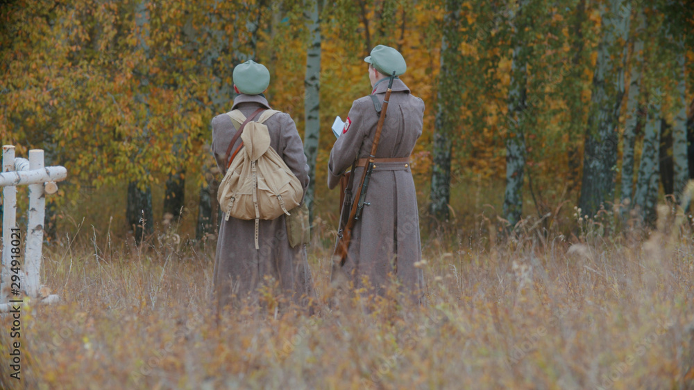 Soldiers are staying on the field and reading a map Soldiers are staying on the field and reading a map