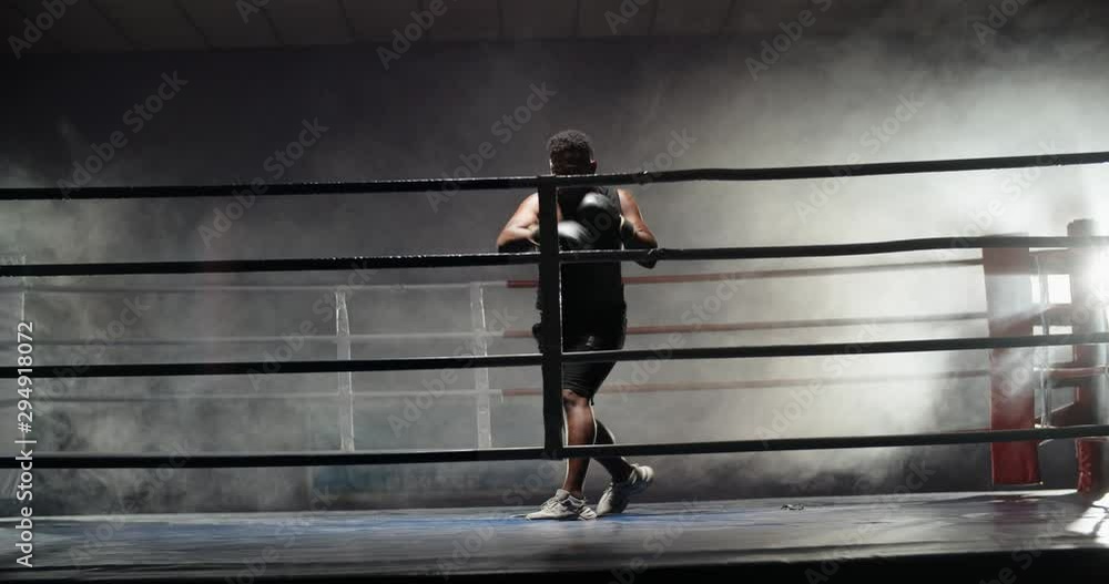 African american sportsman exercising on a boxing ring, doing a shadow fight, preparing for tournament - sports, fitness concept 4k footage African american sportsman exercising on a boxing ring, doing a shadow fight, preparing for tournament - sports, fitness concept 4k footage