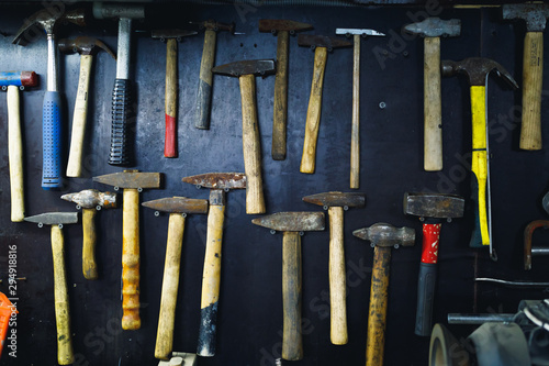 Slika na platnu wall with rusty hammers in old garage