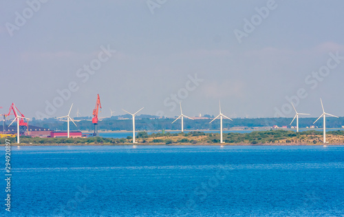 Wind turbines in sea in Copenhagen  Denmark. Offshore wind farm for renewable sustainable and alternative energy production. Green economy. Ecology and environment. Eco power