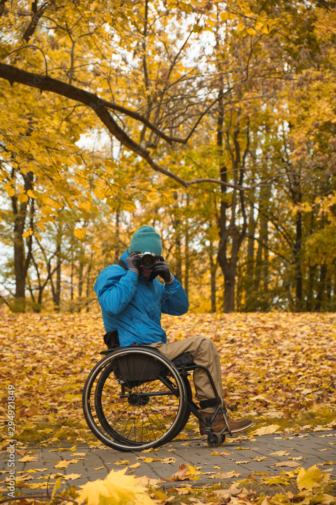 wheelchair - disabled photographer in autumn park wheelchair - disabled photographer in autumn park