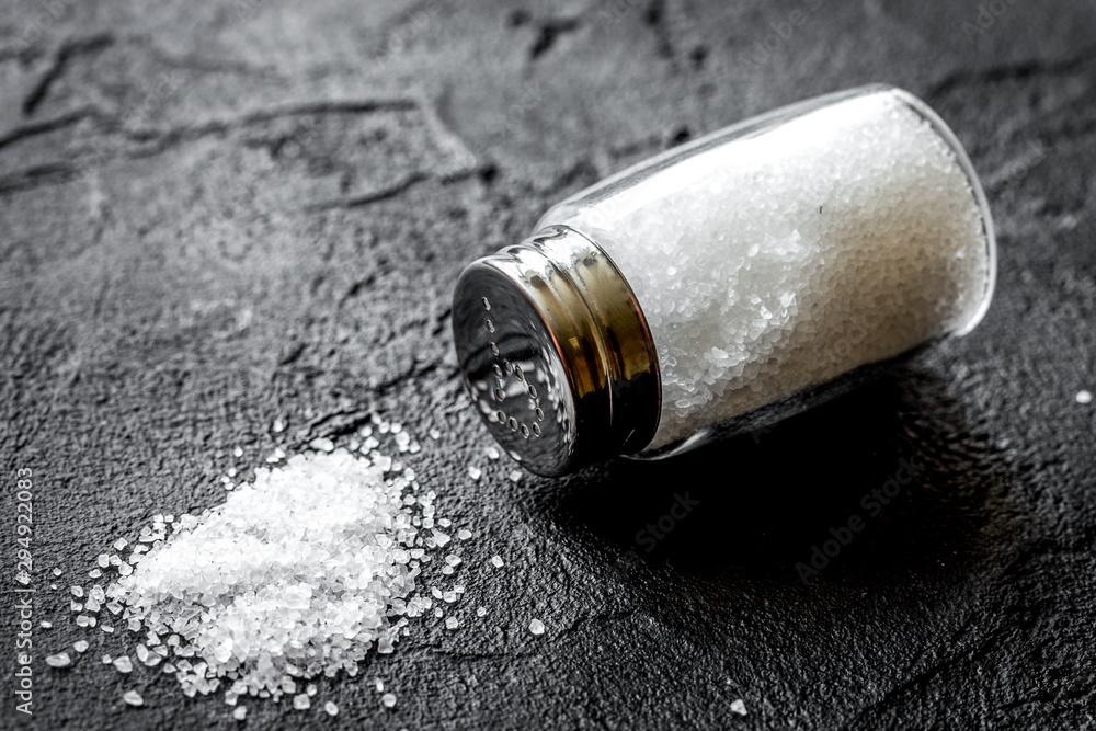 Cooking set with salt in glass bottle on dark background Cooking set with salt in glass bottle on dark background