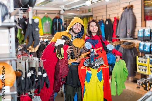 Young couple demonstrating tourist equipment