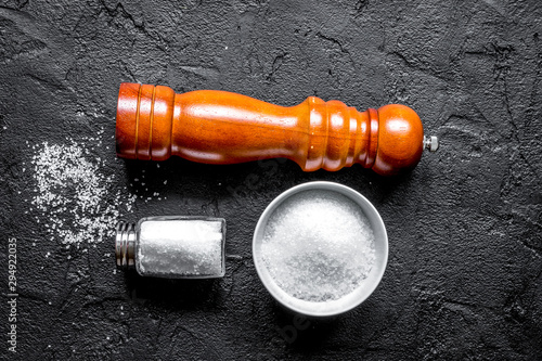 Cooking set with salt and saltcellar on dark background top view