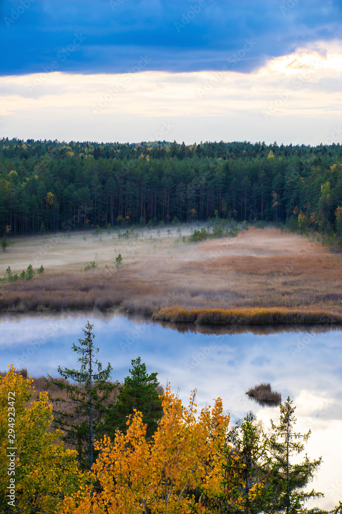 Latvian autumn nature. Forest, fog and Kangari lake. View from the top.