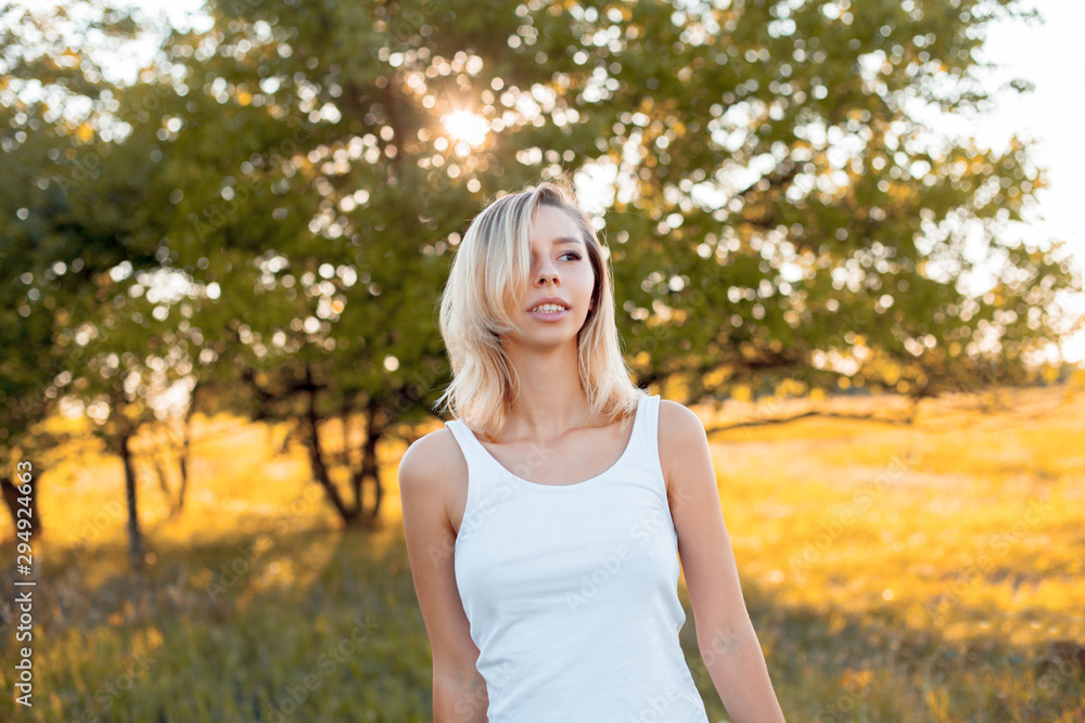 Young woman in white shirt walking outdoors under the daylight