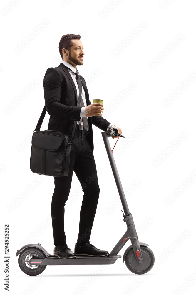 Young professional man with a laptop case and a takeaway coffee on an electric scooter Young professional man with a laptop case and a takeaway coffee on an electric scooter