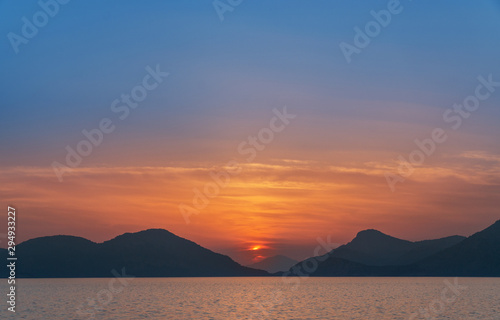 Moon and stars over the calm sea.
