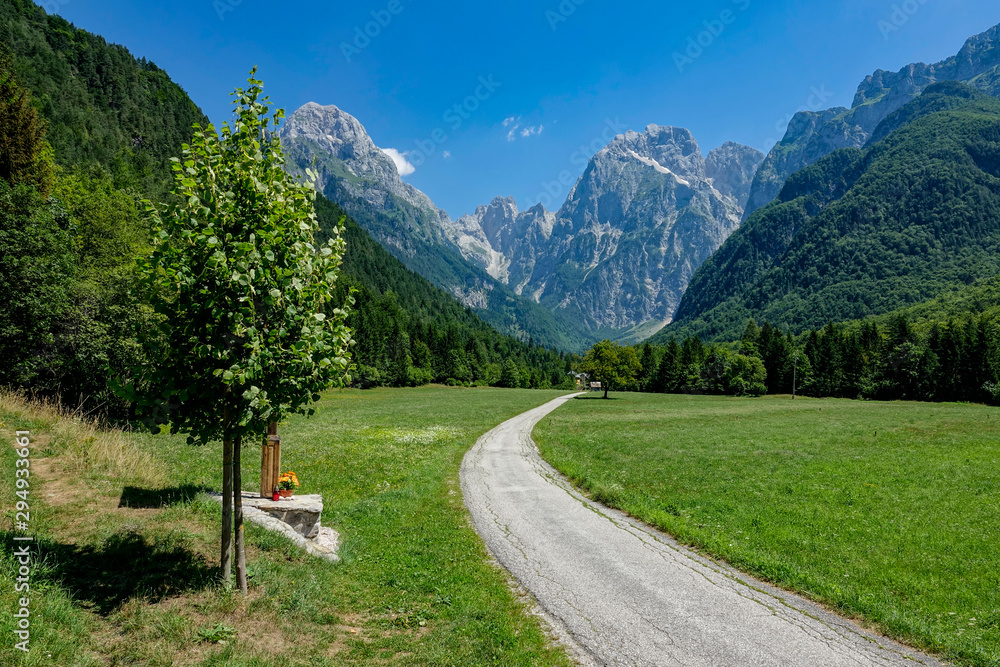 Spectacular shot of rocky Julian Alps towering above the serene countryside.