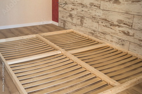 Wooden planks on the bottom of double floor bed.